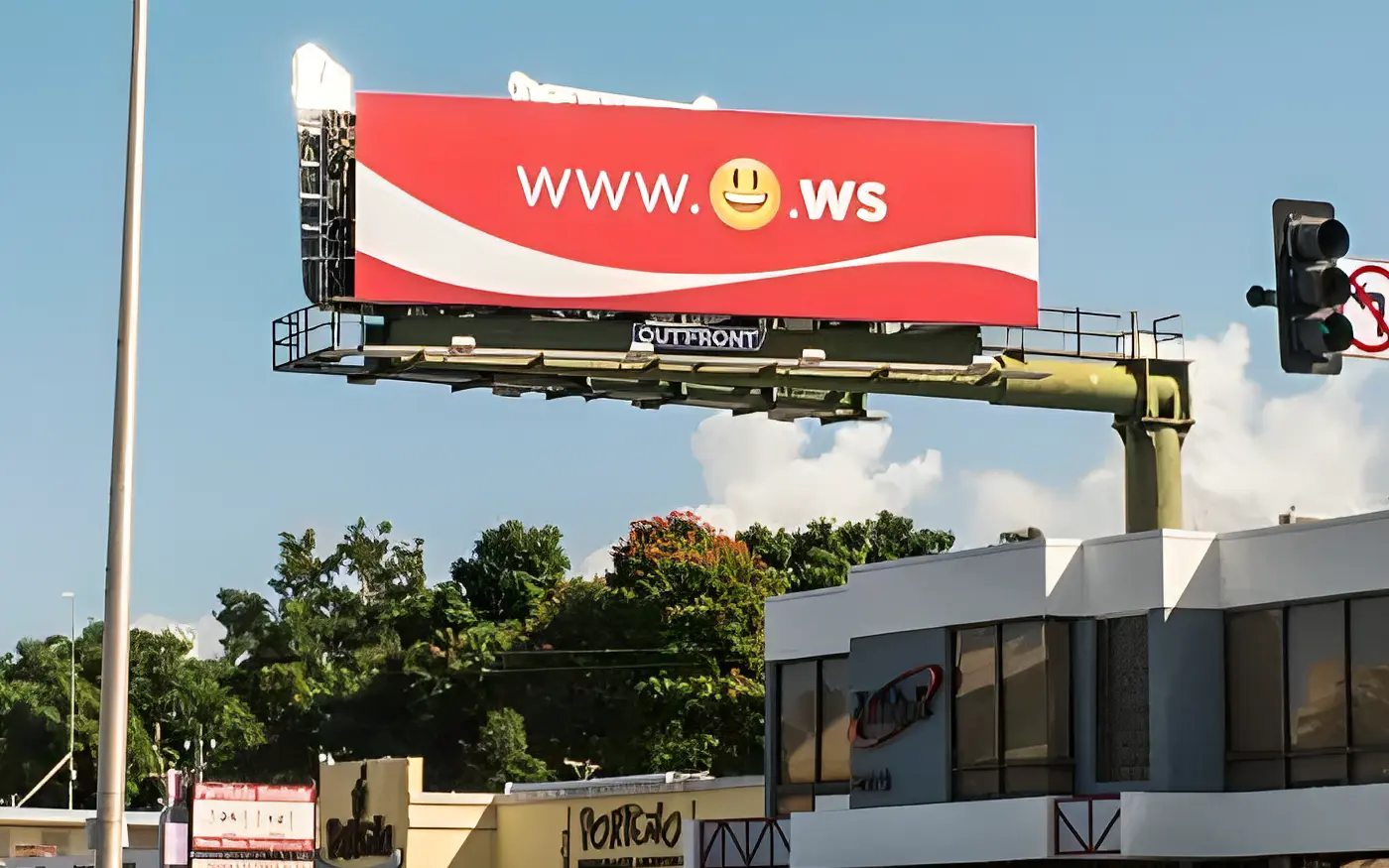 A Coca-Cola billboard in Puerto Rico reading www. followed by a smiling face emoji and .ws